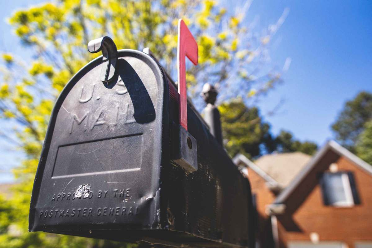 Black mail box with red flag up