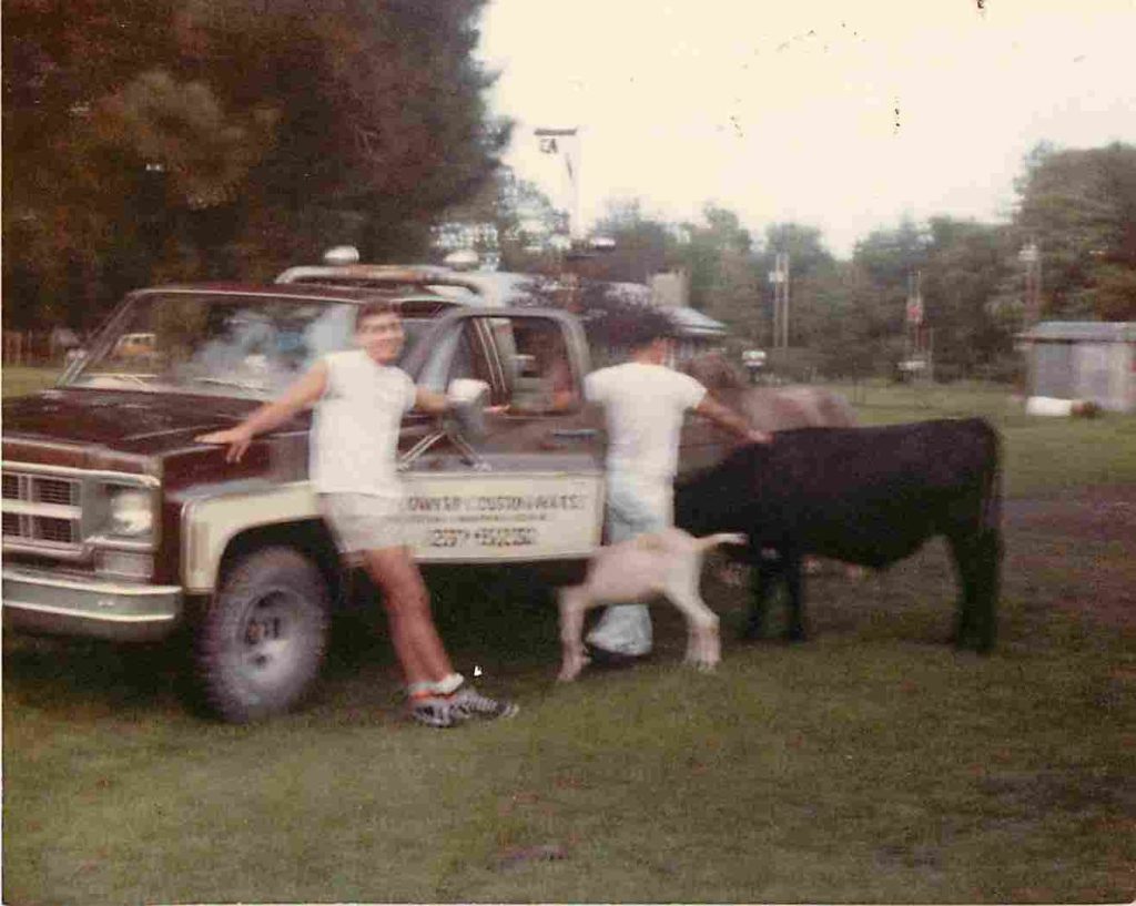 truck with two boys and cows while growing up with Country Meats 