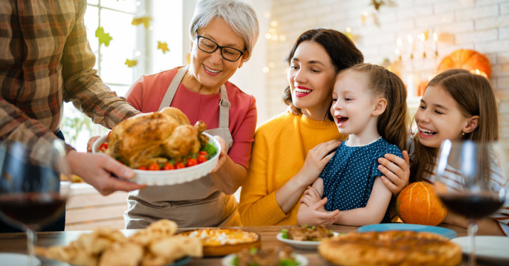 family sitting around the table during Thanksgiving