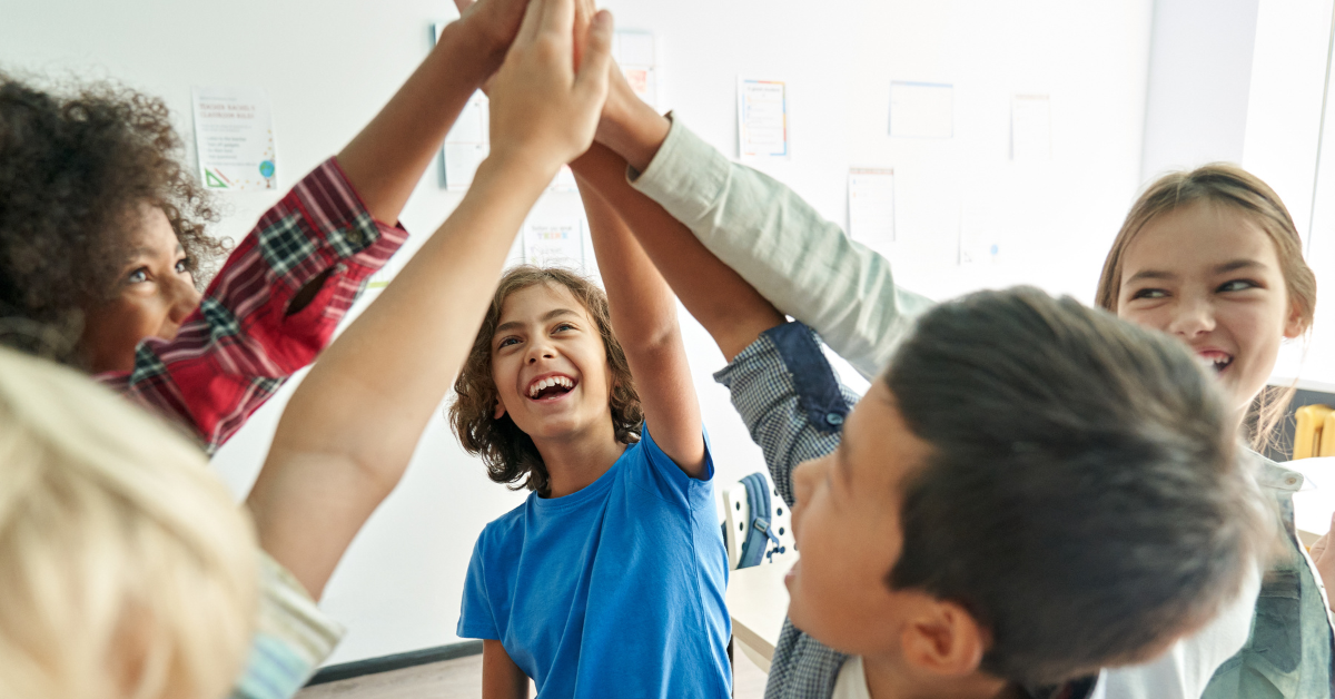 students high fiving in a classroom