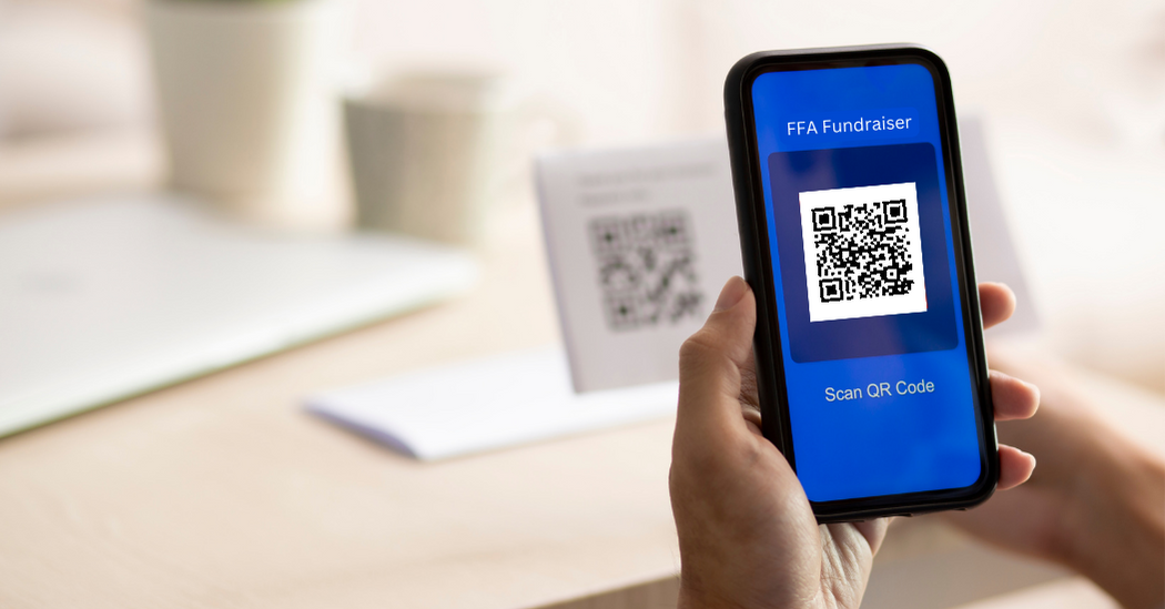 Scanning a QR code with a phone to pay for FFA fundraising